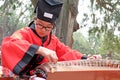 A school child, dressed in the Chinese traditional costume Ã¢â¬â Hanfu clothing, plays Chinese traditional musical instrument Zheng.